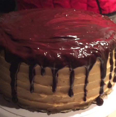 Take Chocolate Ganache and drop at the edge of the cake and let it naturally slide down the sides and then cover the center